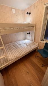 萨伦Perfect winterhouse in Sälen的带两张双层床和椅子的房间
