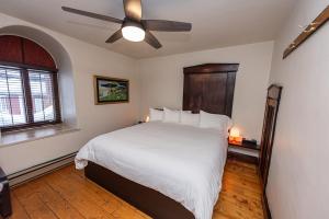 拜圣保罗橙色小栈宾馆的一间卧室配有一张带吊扇的床