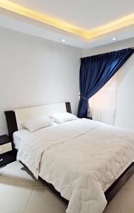 SakumonaThe Hedge的卧室配有白色的床和窗户。