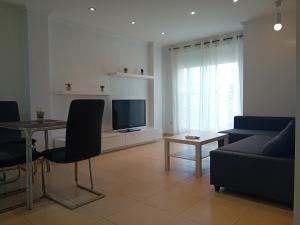 甘迪亚Apartamento Luna的带沙发、桌子和电视的客厅
