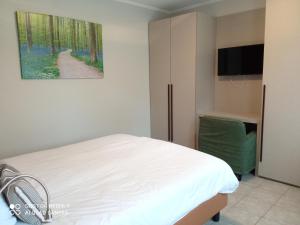 Bour关帝公寓式酒店的一间卧室配有一张床和一台平面电视