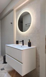 沃洛斯Volos Guesthouse Konstantina的浴室设有白色水槽和镜子