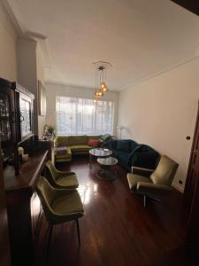 奥斯坦德Charmante Art Deco rijwoning的客厅配有沙发、椅子和桌子