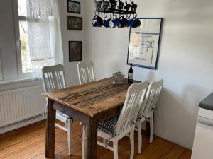 Klingbergromantische Ferienwohnung Sachsenhof 2的一间带木桌和椅子的用餐室
