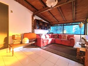 瓜纳华托El Refugio de San Matías的客厅配有红色的沙发和桌子
