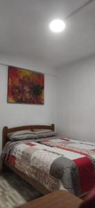 HuantaHOTEL HUANTA - MORENOS的一间卧室设有两张床,墙上挂着一幅画