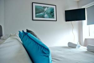 南安普敦Honest Airport University House 1 with FREE PARKING and FAST WIFI的卧室内的白色床和蓝色枕头