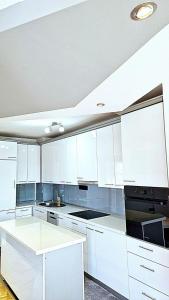 多博伊Apartman Sekulić的白色的厨房配有白色橱柜和水槽