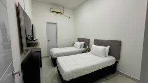 莱蒂西亚Rio Hotel Centro的小房间设有两张床和电视