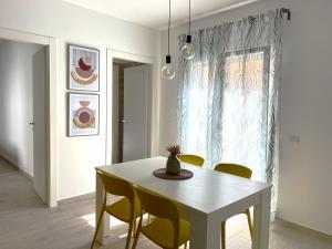 马扎拉德尔瓦洛Volturno3 Suites & more的一间配备有白色桌椅的用餐室
