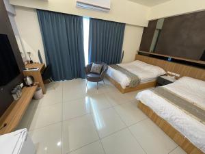 台东孟鍹民宿的酒店客房,配有两张床和椅子