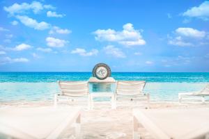 威廉斯塔德帕帕加海滩酒店的海滩上的时钟,椅子和海洋