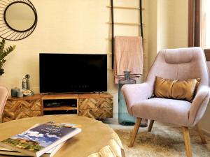 贝莱斯Casa Secreta Vélez-Málaga centro的客厅配有椅子和电视
