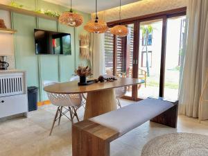 São Gonçalo do AmaranteTaíba Beach Resort por Be My Guest!的一间带木桌和椅子的用餐室