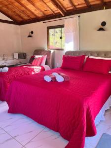 阿尤鲁奥卡Hospedagem Florenza的红色毯子的客房内的两张床