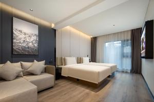 三亚三亚湾凤凰路亚朵酒店的酒店客房,配有床和沙发