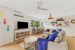 黄金海岸Bilinga Bliss - Luxury beachfront apartment的带沙发和电视的客厅