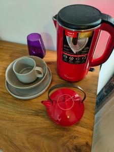 科伦坡Cozy Apartment的红咖啡壶和桌子上的杯子和盘子