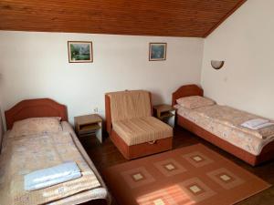 科拉欣Vila Rakoč的一间设有两张床和椅子的房间