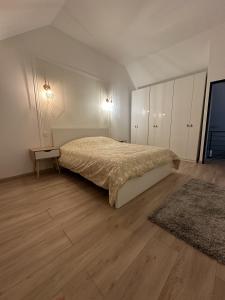 Saint-Georges-sur-BaulcheMaison design de 190m2的一间卧室配有一张床,铺有木地板