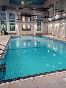 福伊Wyndham Trenython Manor的大楼内一个蓝色的大型游泳池