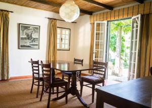 里斯本Quinta do Archino 18的一间设有玻璃桌和椅子的用餐室