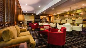 维塞乌格劳瓦斯科酒店的酒吧设有红色和白色的椅子和桌子