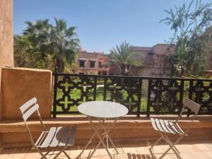 马拉喀什La Perle de Marrakech by Atlas Golf Resort的阳台上配有白色的桌椅