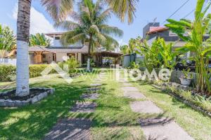 帕里普埃拉Casa a 5 minutos das Piscinas Naturais em Alagoas的棕榈树屋前的走道