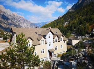 瓦勒博内BUJTINA Valbonë的山中一座大房子,背景是群山