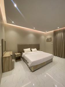 欧拉شقق نور سين的卧室配有一张白色大床和电视。