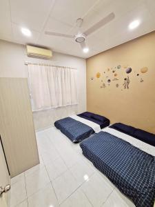 居銮23 Sri Kluang HomeStay - Up to 15pax的两张床位于带行星墙的房间