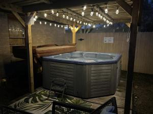 拉伯克Luxury Oasis- 1 bedroom romantic getaways的室外热水浴池,位于带灯光的房间