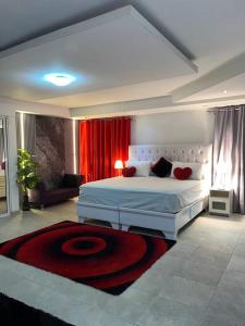 圣多明各Penthouse Bella的一间卧室配有一张大床和红色窗帘