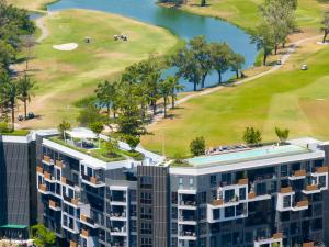 邦涛海滩Апартаменты в Laguna Skypark с террасой的享有大楼和高尔夫球场的空中景致