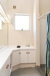 皇后镇皇后镇哈卡旅舍的白色的浴室设有水槽和窗户。