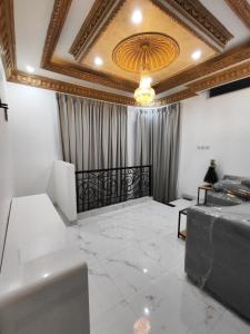 雅加达Rumah liburan 2 bedroom, 1 sofabed, 1 kitchen的大房间设有天花板和吊灯