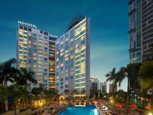 马尼拉Novotel Manila Araneta City Hotel的大楼前有游泳池的酒店