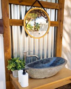 克莉丝蒂娜岛Kampaoh Isla Cristina的一间带大型石质水槽和镜子的浴室