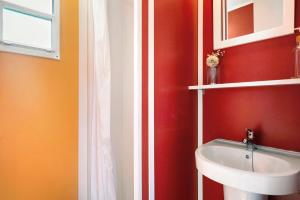 埃尔帕尔马Linda casita的一间带水槽和红色墙壁的浴室