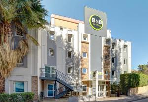 马赛B&B HOTEL Marseille Parc Chanot的前面有标志的建筑