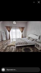 SinyakRelax villa Poduzska的一间卧室设有一张大床和一个窗户。