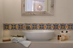 托里德欧索Borgo Sentinella的浴室配有盥洗盆、镜子和毛巾