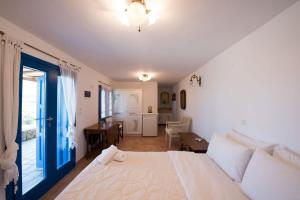 法蒂亚Villa Victoria with Sea View and Two Private Pools的卧室配有白色的床和蓝色的门