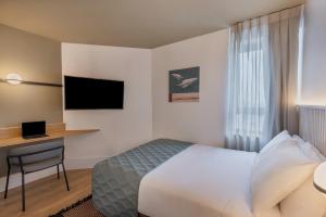 特拉维夫大都会酒店的配有一张床和一张书桌的酒店客房
