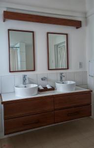 Grand BrasRainbow Inn的浴室设有2个水槽和2个镜子