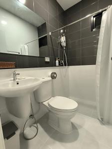 清莱Baan Trin(บ้านตฤณ)的浴室配有白色卫生间和盥洗盆。