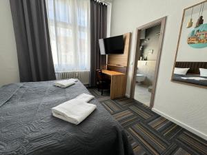 柏林Hotel Bregenz的酒店客房,配有带毛巾的床