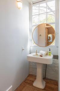 查尔斯顿Gibbon House at Casa Zoe的浴室设有白色水槽和镜子