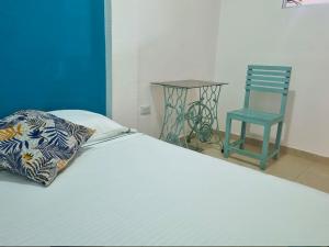 帕洛米诺Apartamento Privado Palomino的一张带枕头的床和一把椅子